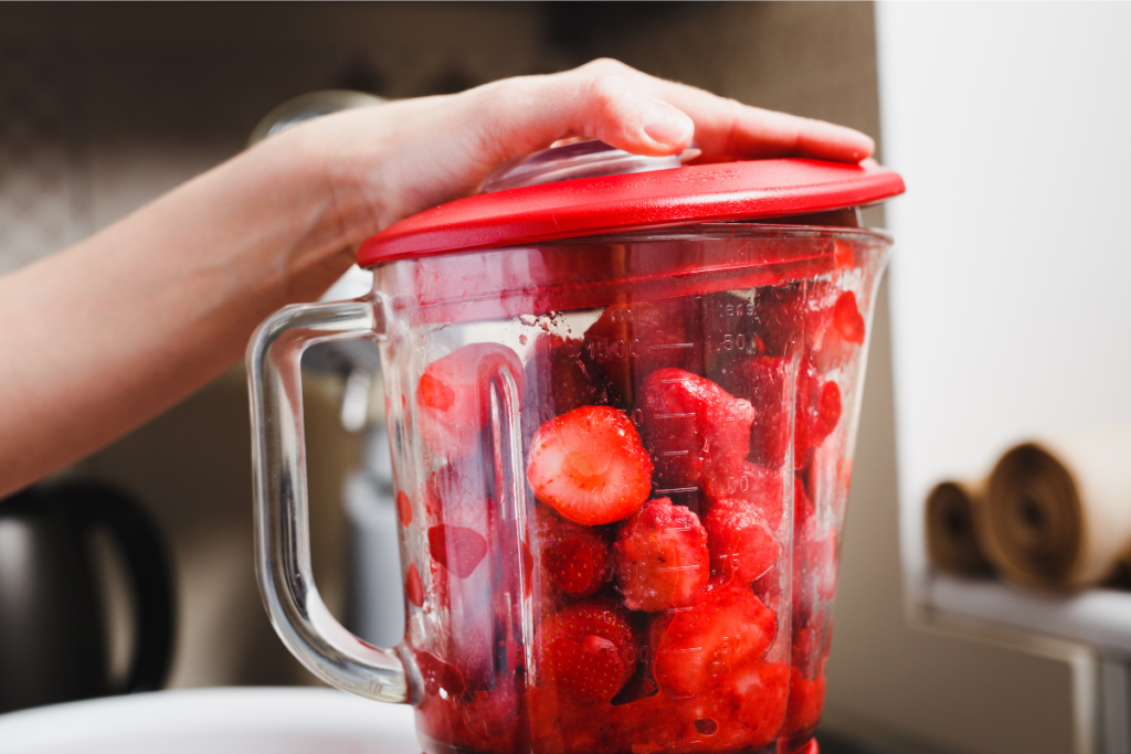 Strawberries in a blender for making homemade purée