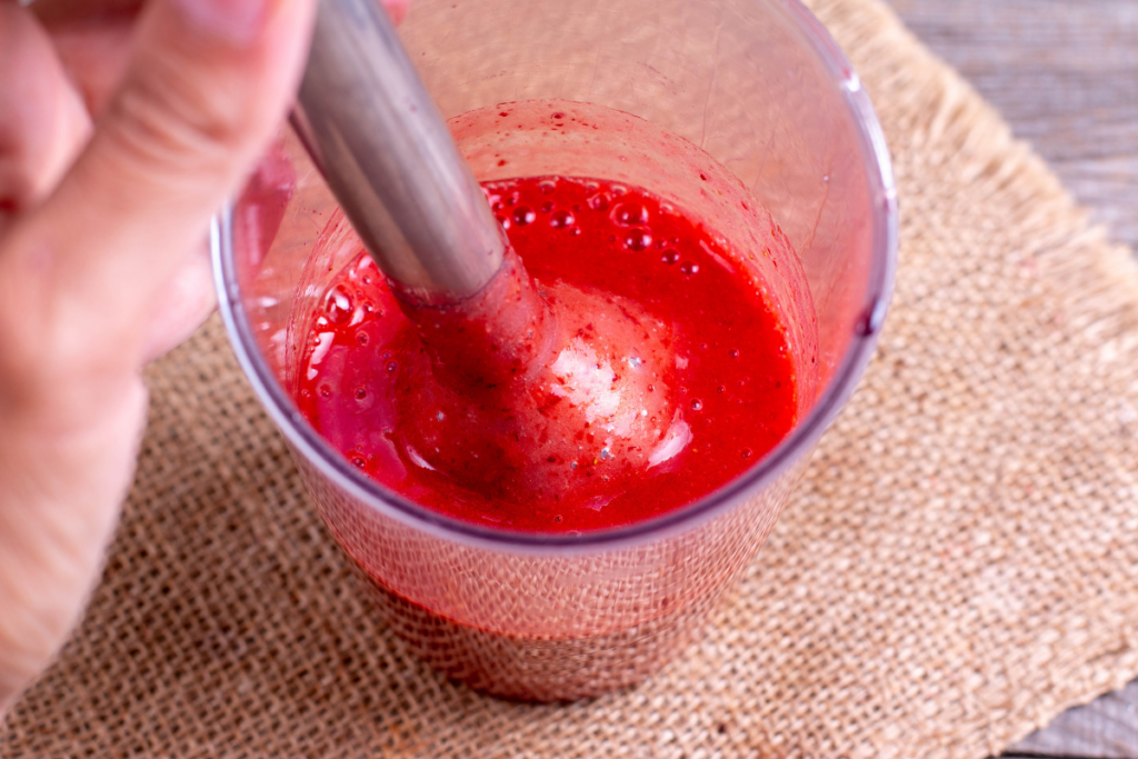 Smooth and vibrant homemade strawberry purée in a jar