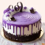 Ube Cake: The Fluffy Filipino Dessert Everyone’s Obsessed With 5 Assorted Filipino ube cakes with purple frosting, drip icing, and chocolate decorations on rustic tables.