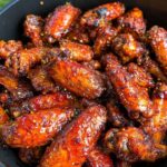 Why Chili Oil Chicken Wings Deserve a Spot on Your Table 5 Chili oil chicken wings coated in a spicy, glossy red glaze with garlic and chili flakes