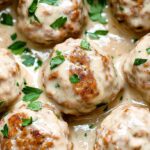 Crockpot Swedish Meatballs Recipe: The Easiest Way to Make Creamy, Tender Meatballs at Home 4 Close-up of crockpot Swedish meatballs covered in creamy gravy and garnished with chopped parsley.