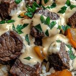 Cheesy Steak & Rice: A Tex-Mex Comfort Food Favorite for Busy Nights 5 Gourmet steak and rice with melted cheese sauce and fresh herbs.