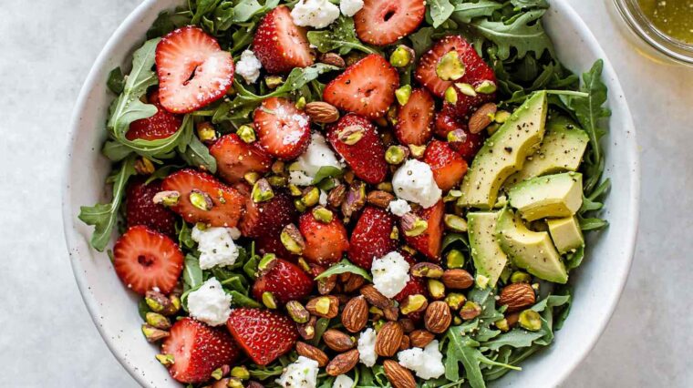 Strawberry Crunch Salad: Sweet, Crunchy & Fresh Summer Favorite 6 Gourmet strawberry avocado salad with arugula, feta, almonds, pistachios, and champagne vinaigrette.