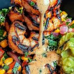 Grilled Shrimp Bowl with Avocado, Corn Salsa and Creamy Sauce: Summer Dinner Recipes 3 Close-up of grilled shrimp bowl with creamy sauce, corn salsa, red onions, tomatoes, and guacamole