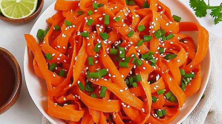 Raw Carrot Salad (5-Minute Viral TikTok Recipe!) 5 Colorful raw carrot salad with green onions and sesame seeds in a white bowl