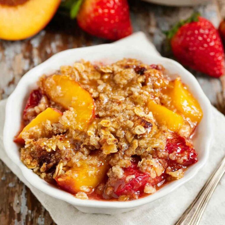 Strawberry Peach Crisp: The Perfect Summer Dessert with a Golden Oat Topping 7 strawberry peach crisp with golden oat topping served in a white bowl